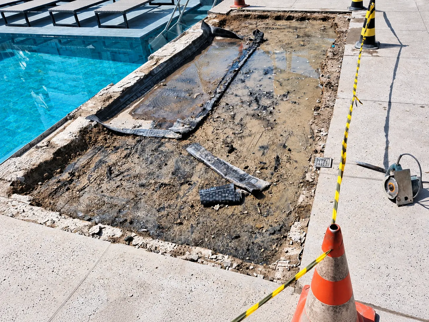 Escavação e demolição em área externa próxima à piscina executada pela JM Construções